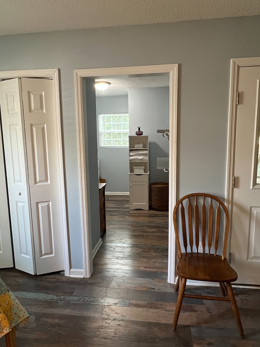 Additional storage room with two shelves and linen tower.Lin