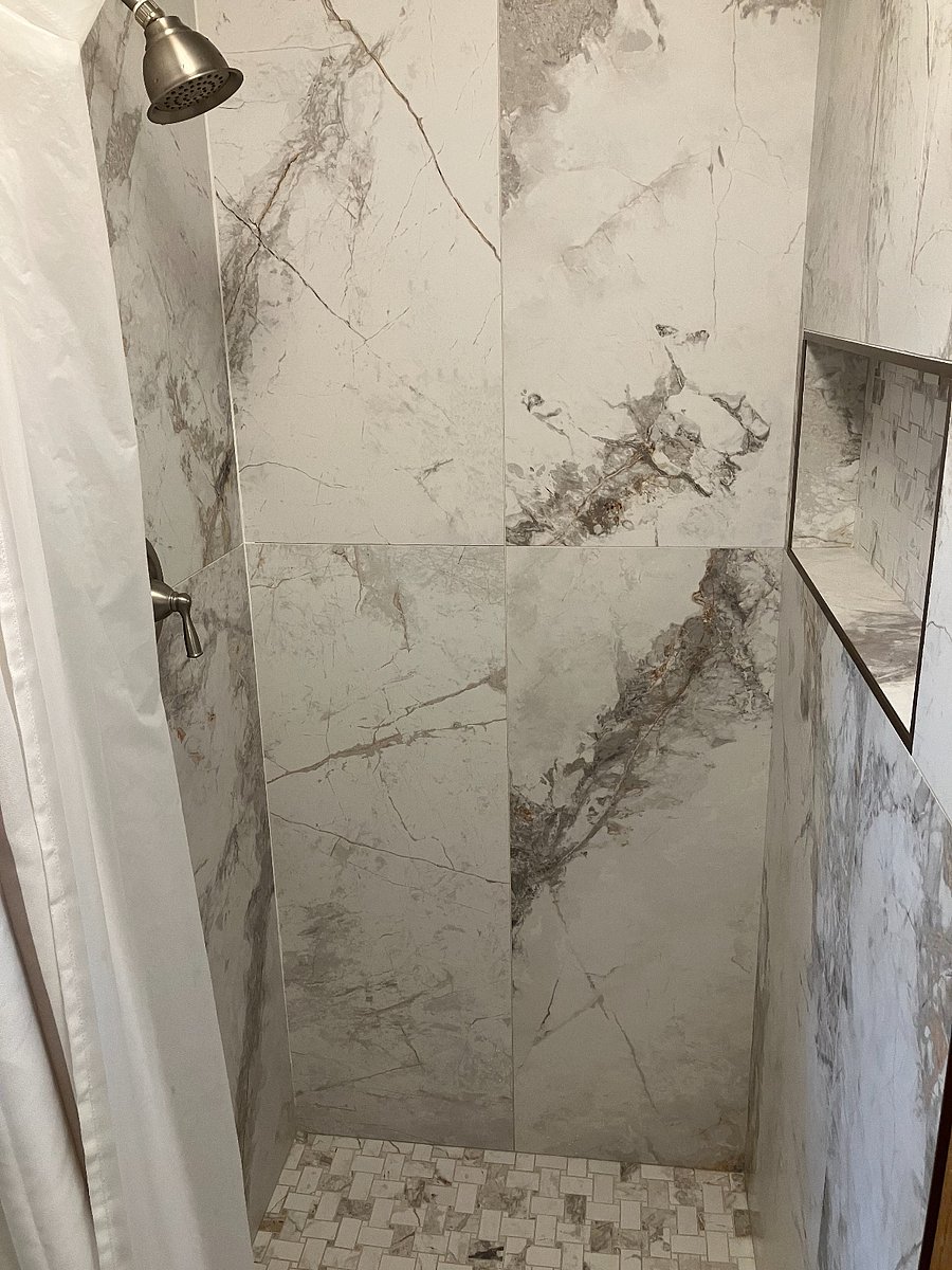 Standing shower attached to soaking tub with Italian Porcelain Tile