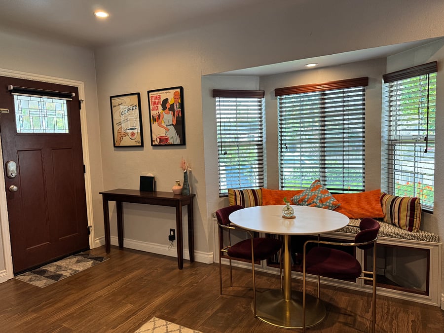 Front door & eating nook. Vinyl record player with LPs in bay window center storage.