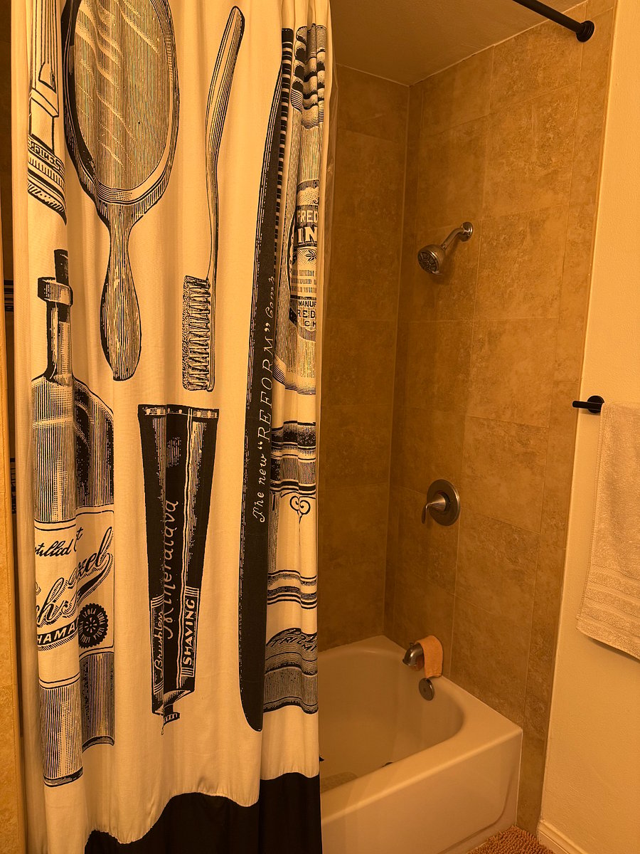 Spacious shower with bathtub.