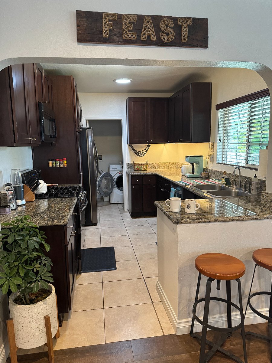 Fully stocked kitchen with stove, oven, dishwasher, coffee, and washer & dryer closet.