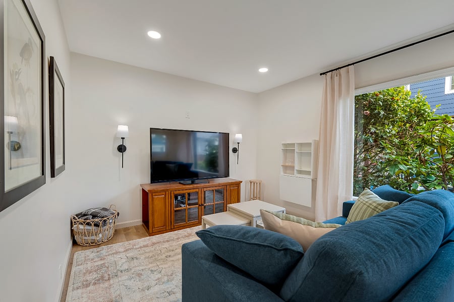 Includes Roku TV and Pop-up Desk. Light-filtering shade is installed on large window for privacy.