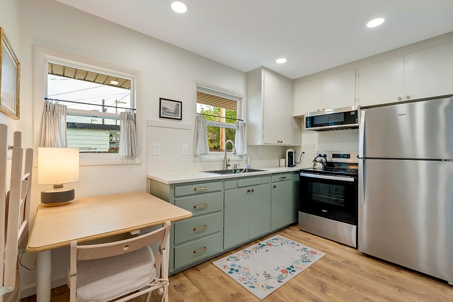 Kitchen is equipped with full size appliances, full set of pots/pans, all common cooking utensils, and starter soap/sponges.