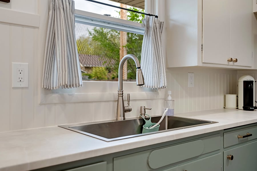 Deep sink features a pull down spray faucet.