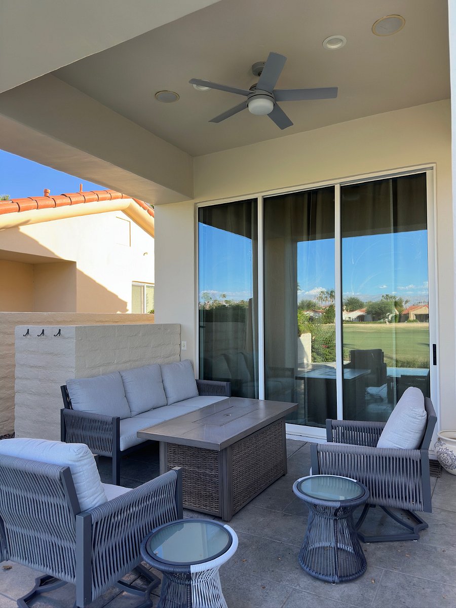 Backyard covered patio with ceiling fan and fire pit