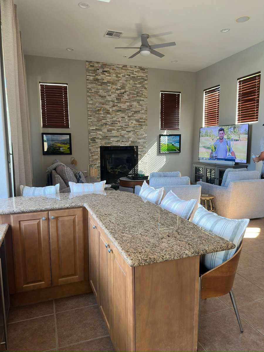 Sunken wet bar with storage and seating for 5 and family room with cable TV, smart TV, Sonos speakers.
