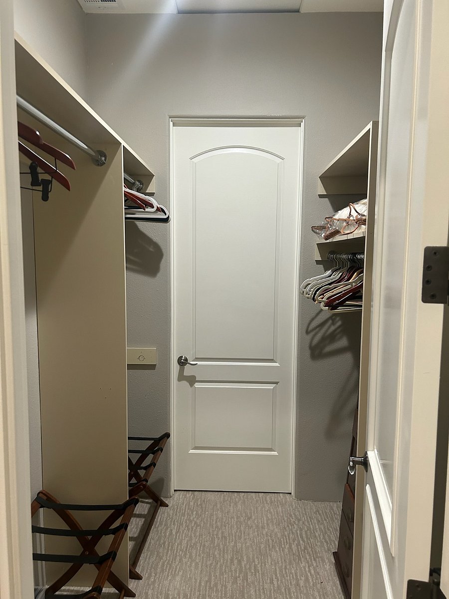 Primary bedroom walk in closet