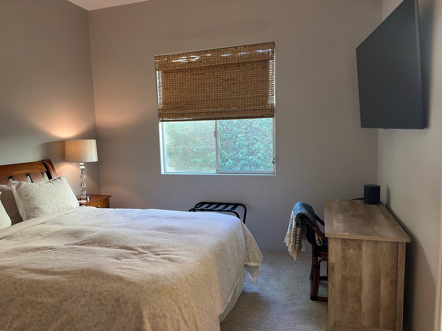 Bedroom #3 with Queen bed, ceiling fan, smart TV, desk/vanity, and Sonos speaker.