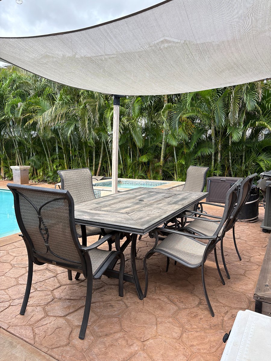 Outdoor table and chairs to eat meals in the tropical backyard
