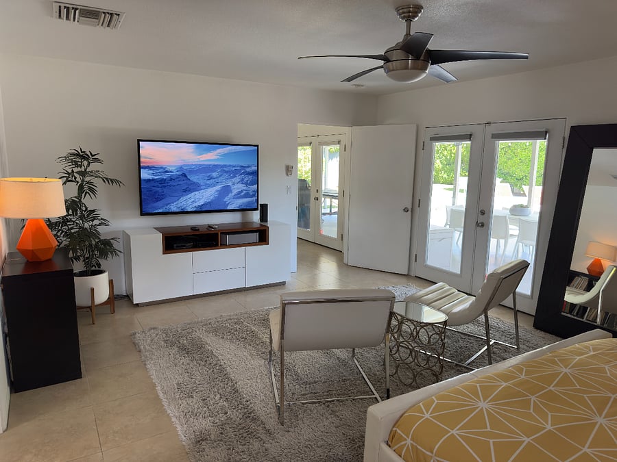 HUGE Primary Suite features French doors to pool and spa, telescoping 62" TV with Surround Sound and an oversized ensuite bathroom.
