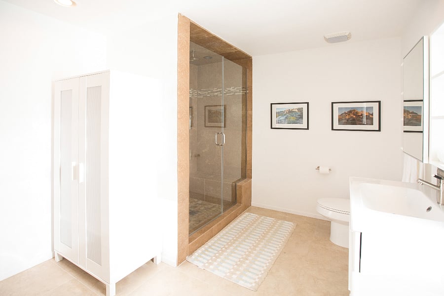 Massive Primary Suite bathroom with multiple showerheads, double vanity and storage.