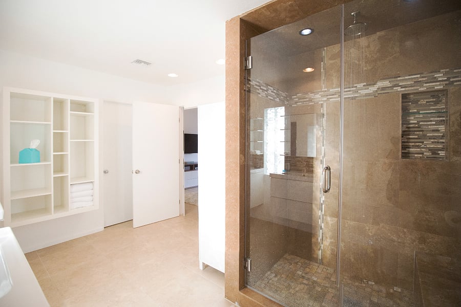 Massive Primary Suite bathroom with multiple showerheads, double vanity and storage.