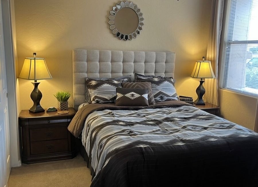 Queen bed in guest room with TV on Adjacent wall also, including full closet