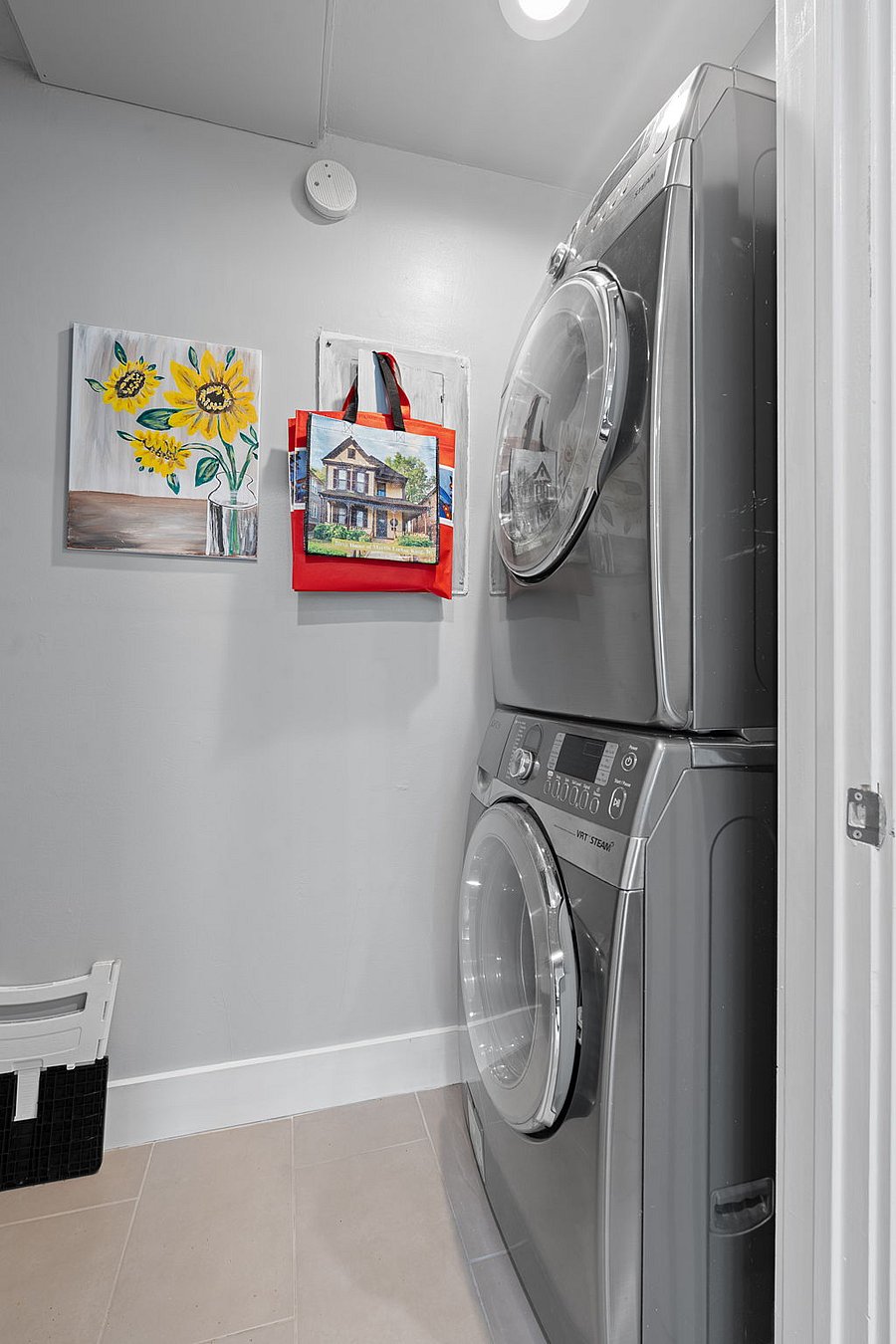 Here's the full-size stackable washer/dryer which faces pantry shelves on the opposite wall.