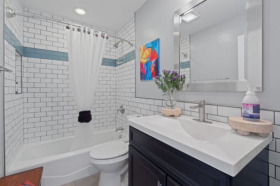 Guest bathroom with a tiled shower and tub. 