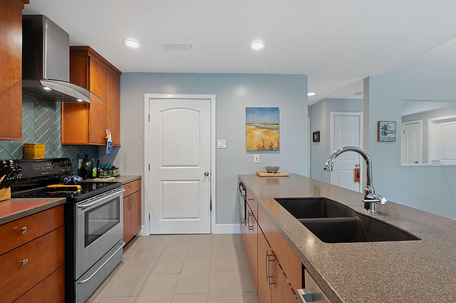 A lot of prep space is made possible with the microwave sitting below the counter on the far right side. The door in the picture leads to a small pantry on one side and a stackable washer/dryer on the opposite side.