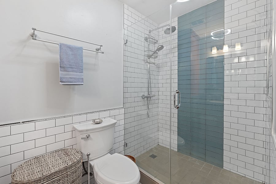 A large glass shower stall in the main bathroom.