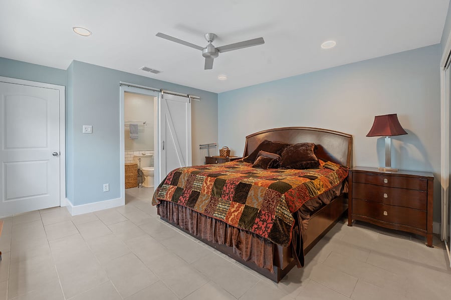 King-sized bed and matching night stands. Access to the main bathroom is thru this main bedroom. 