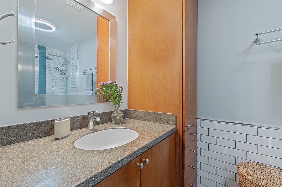 A spacious vanity with a towel and toiletries closet inside the main bathroom.