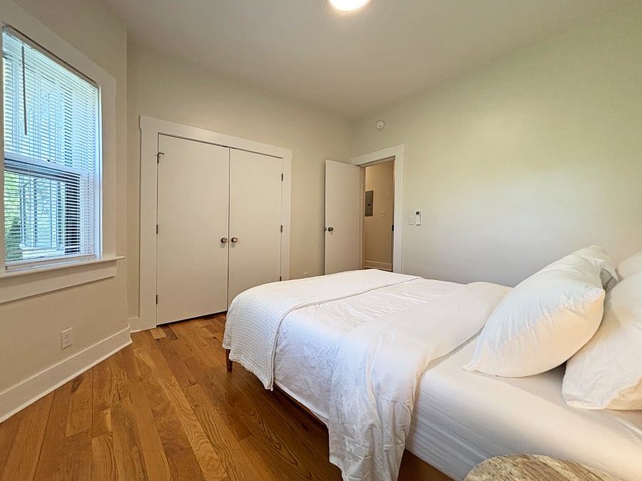 Bedroom with queen bed, luxury mattress and high quality cotton linens. Marble bed side tables with lamps and large reach in closet.