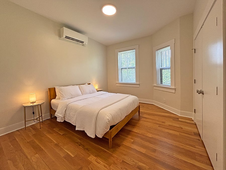Bedroom with queen bed, luxury mattress and high quality cotton linens. Marble bed side tables with lamps and large reach in closet.