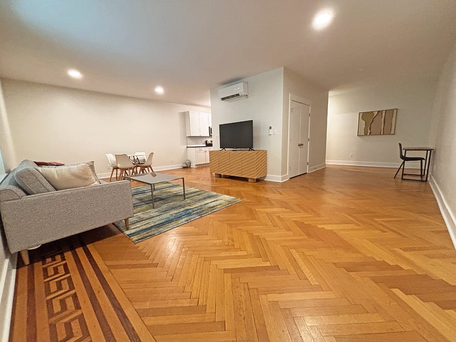 Living area with West Elm and Crate & Barrel furnishings and brand new 55" Roku Smart TV.