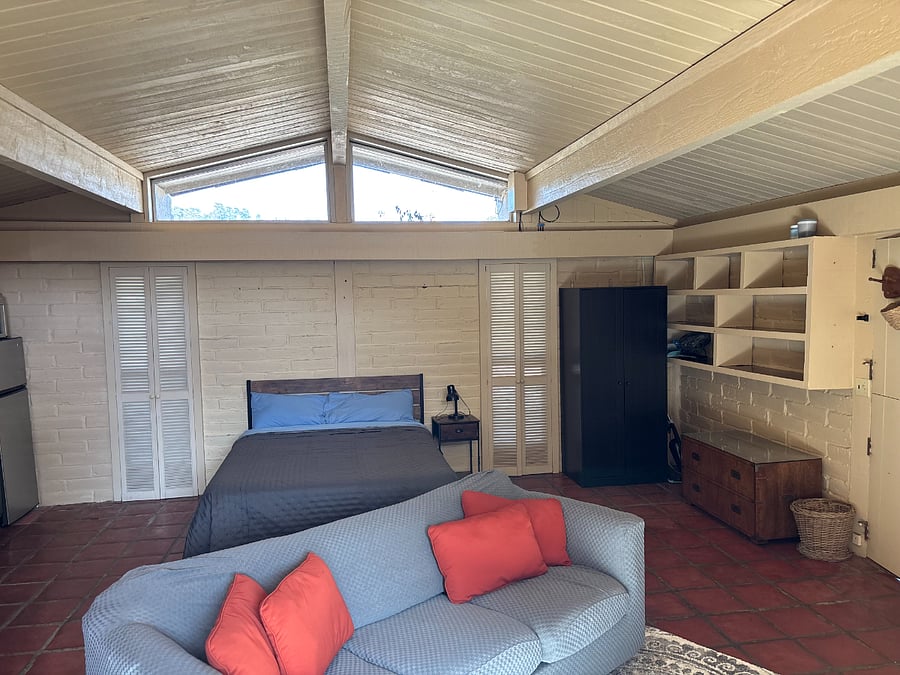 Queen size bed with lots of natural light and vaulted ceilings.