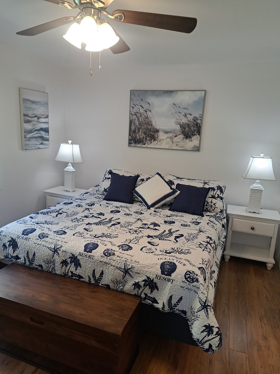 New California King Bed in this large bedroom. Beachy Pictures on walls.