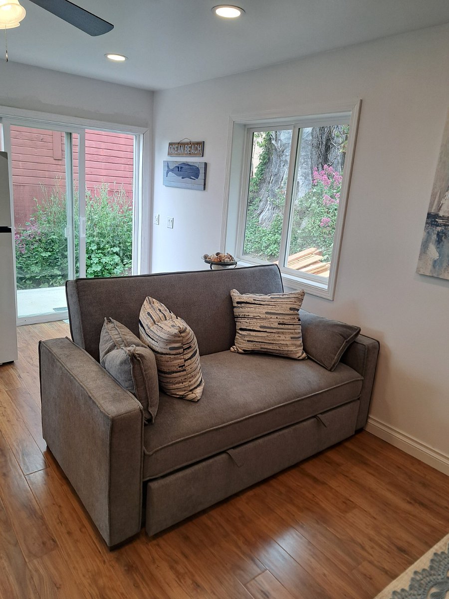 Sofa in living room folds into a full size bed for guest