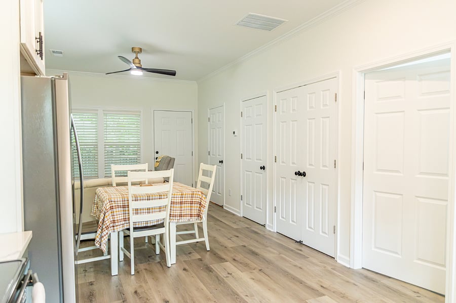 Stacked washer/dryer behind double doors.