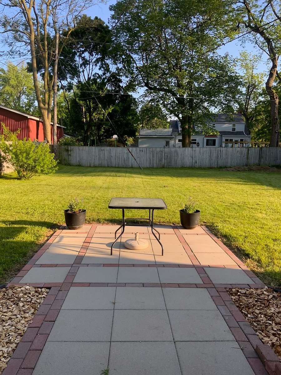 Fully enclosed backyard, with patio, chairs, and propane grill (not pictured)