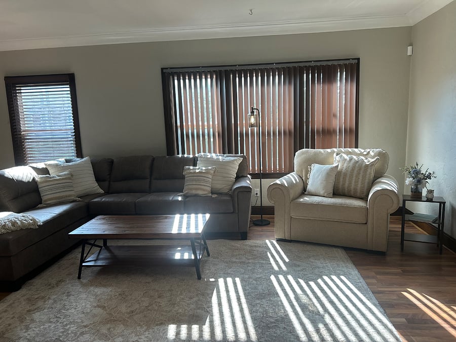 View of that natural light midday with the blinds slightly opened. All three windows give you visibility to the front yard. 