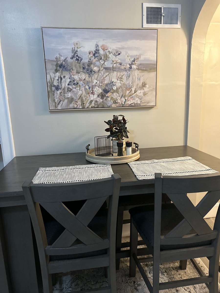 Closer view of table top and wall decor. 

All new while cabinets have been installed. Waiting on the countertops to be installed and the kitchen is done! 