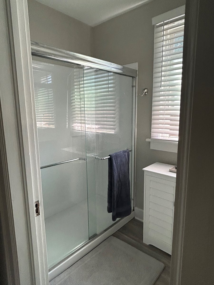 Fully renovated bathroom that is just inside the kitchen off your office and bedroom! We completely renovated this bathroom and installed a new shower, storage and vanity. 
