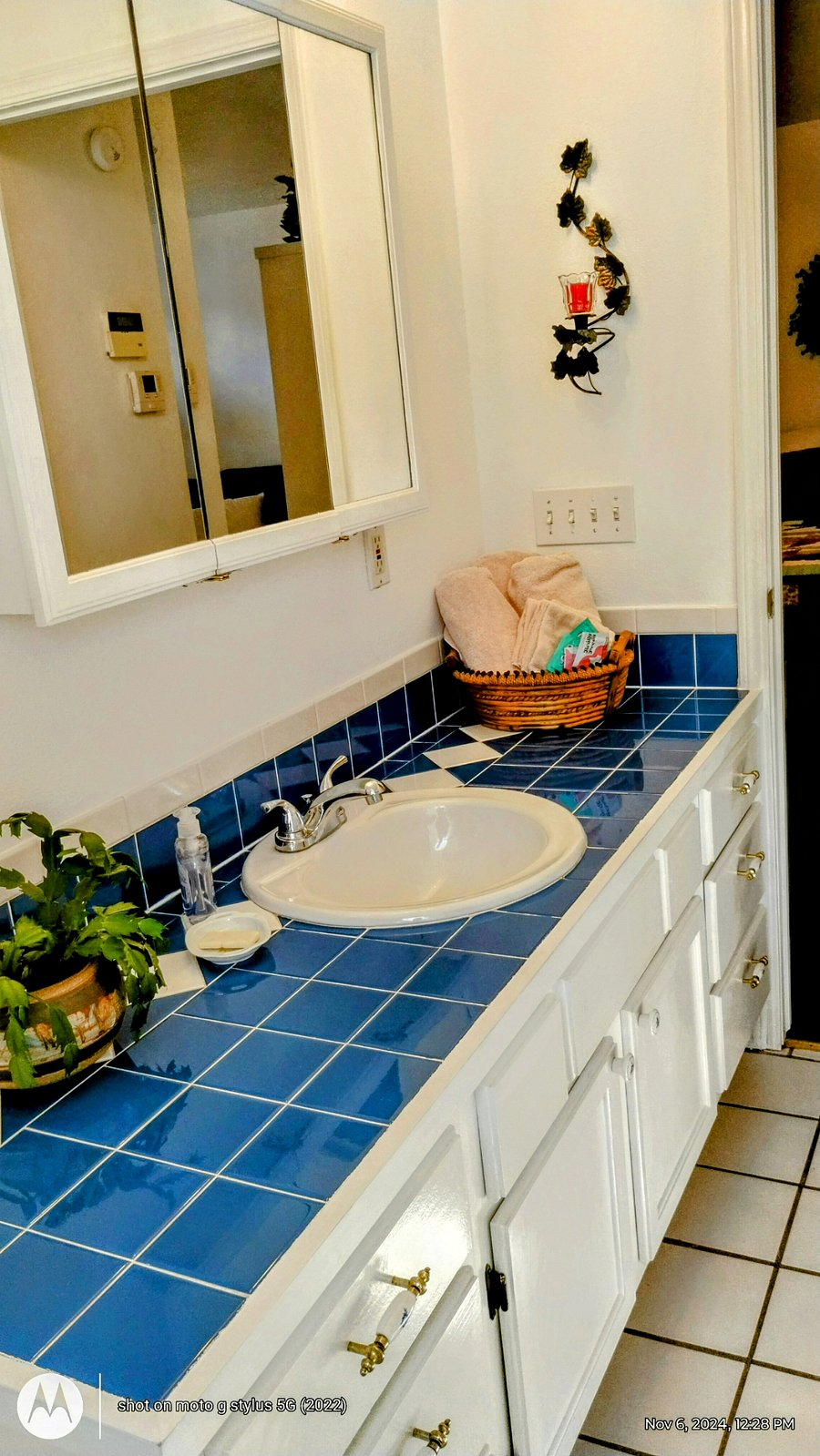 Large vanity, and sink with storage and medicine cabinet above for more storage.