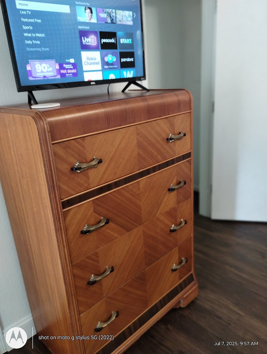 Full size chest of drawers and Smart TV in bedroom. 