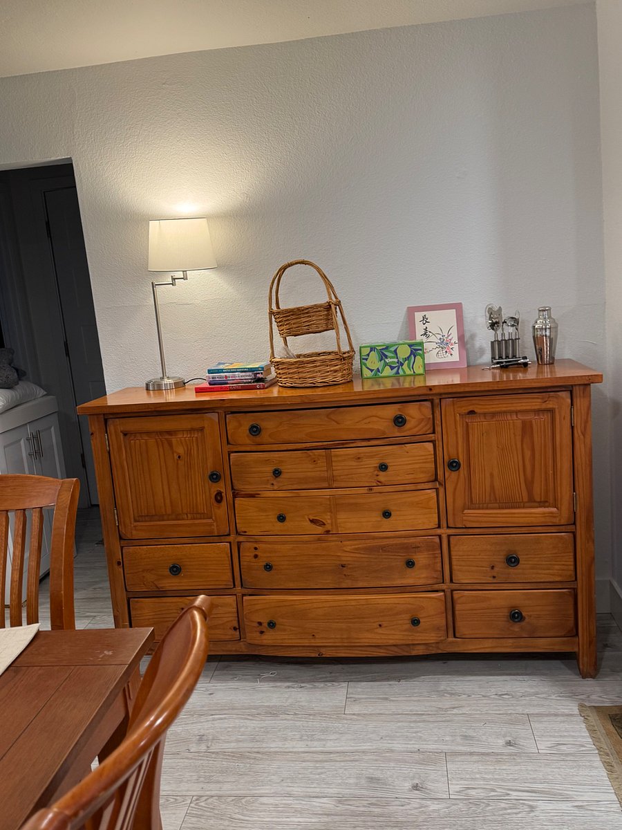 Sideboard in the dining area stores linens (placemats and napkins) as well as books and games. Plus bar tools!