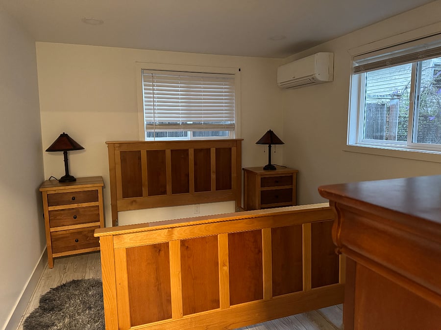 Back bedroom has queen sized bed, nightstands, lamps with mica shades, a bureau and a closet.
