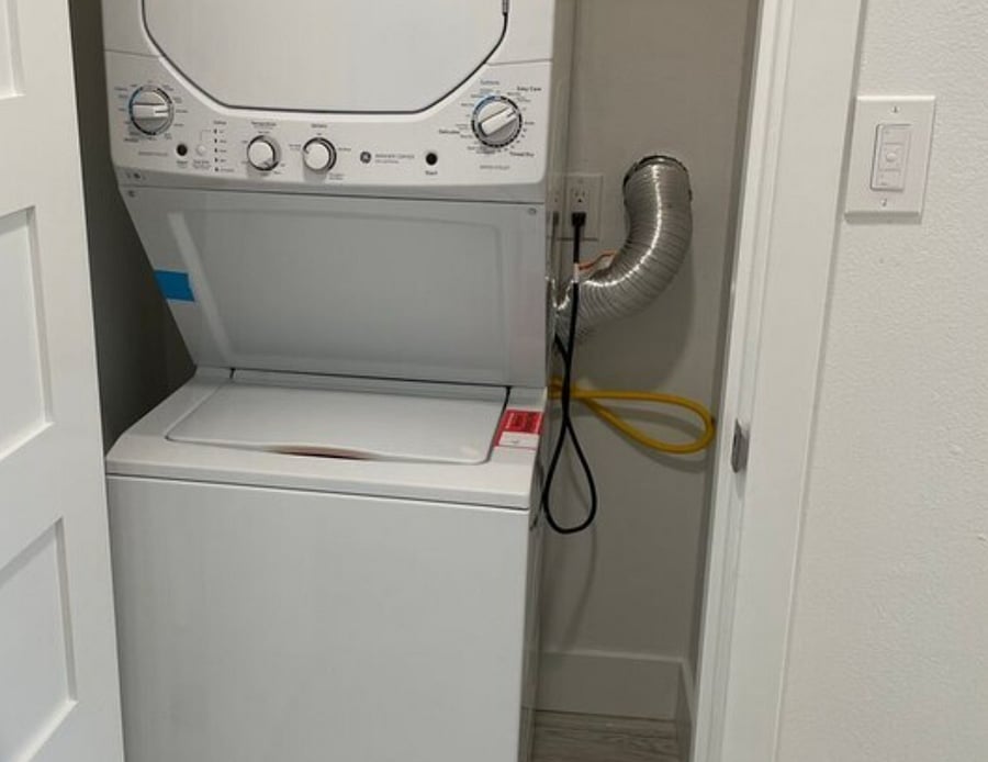 A stacking washer and dryer are in the house for your use.