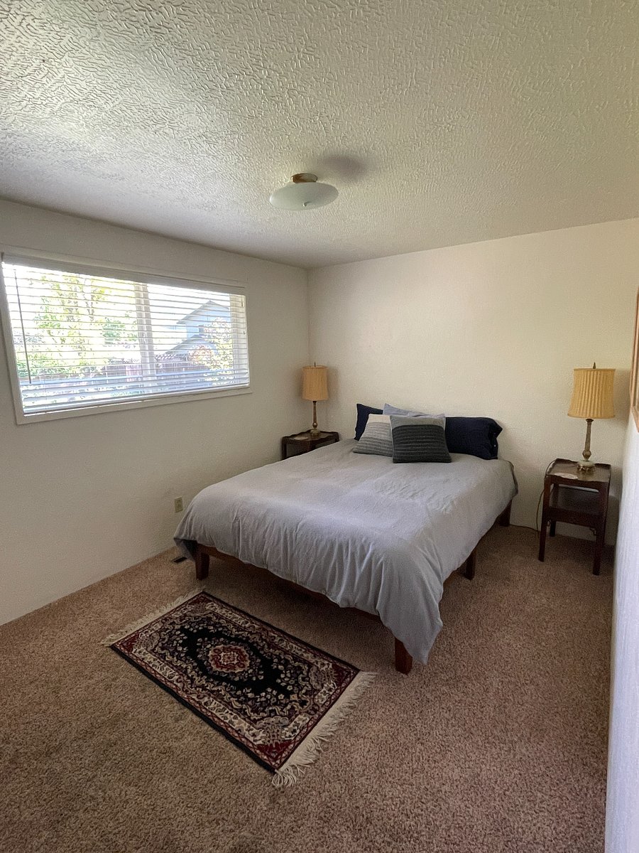 Bedroom 2: queen bed and window overlooking backyard and East hills