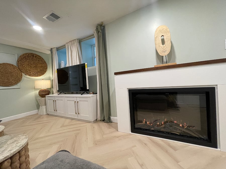 Electric fireplace with remote control provides controllable heat  option settings and ambient light.