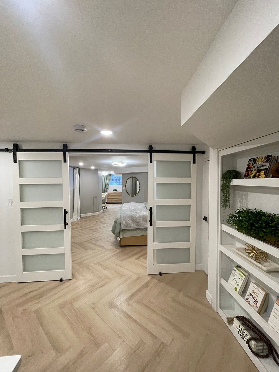 Sliding barn doors provide privacy and separation from open floor plan. Privacy glass allows for sunlight