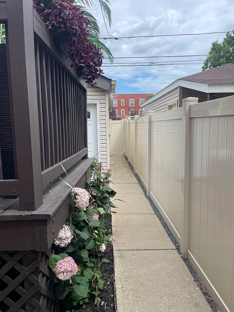 Rear fenced in walkway from apartment to patio and garage.