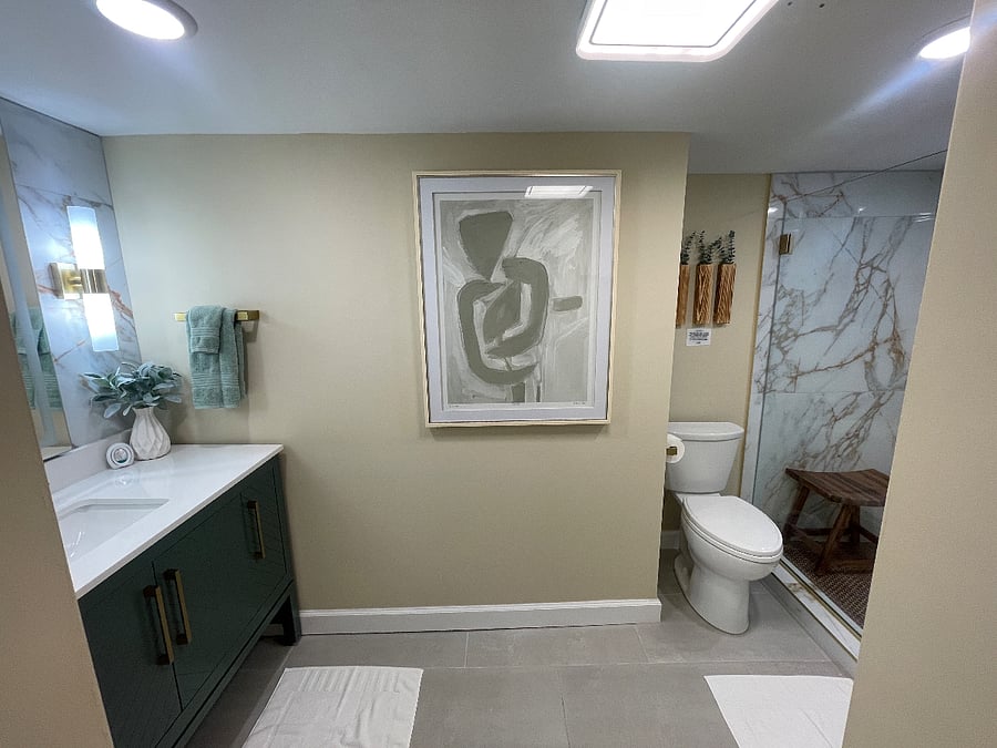 Modern, well lit, with natural light. Shower stool for rest and relaxation.