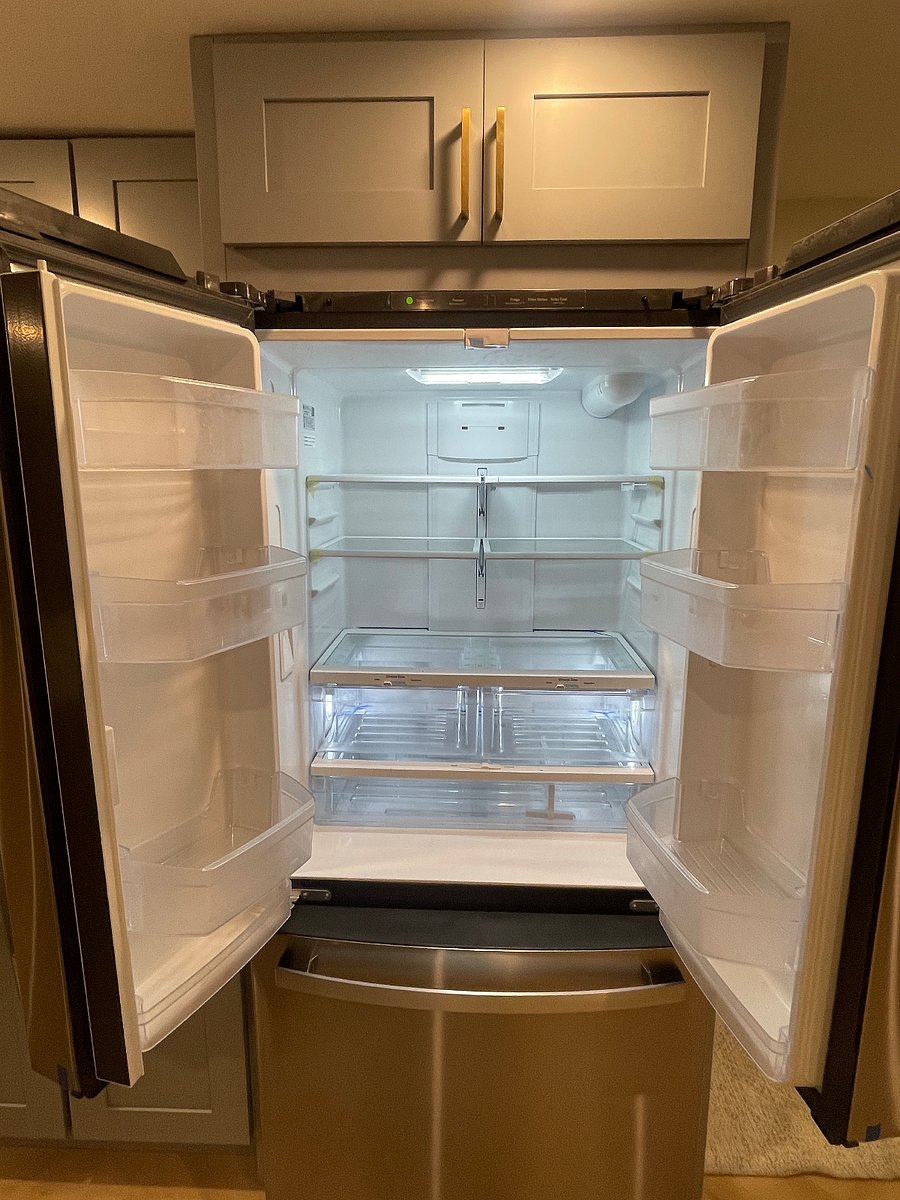 New full size refrigerator with filtered water and bottom freezer with ice maker.