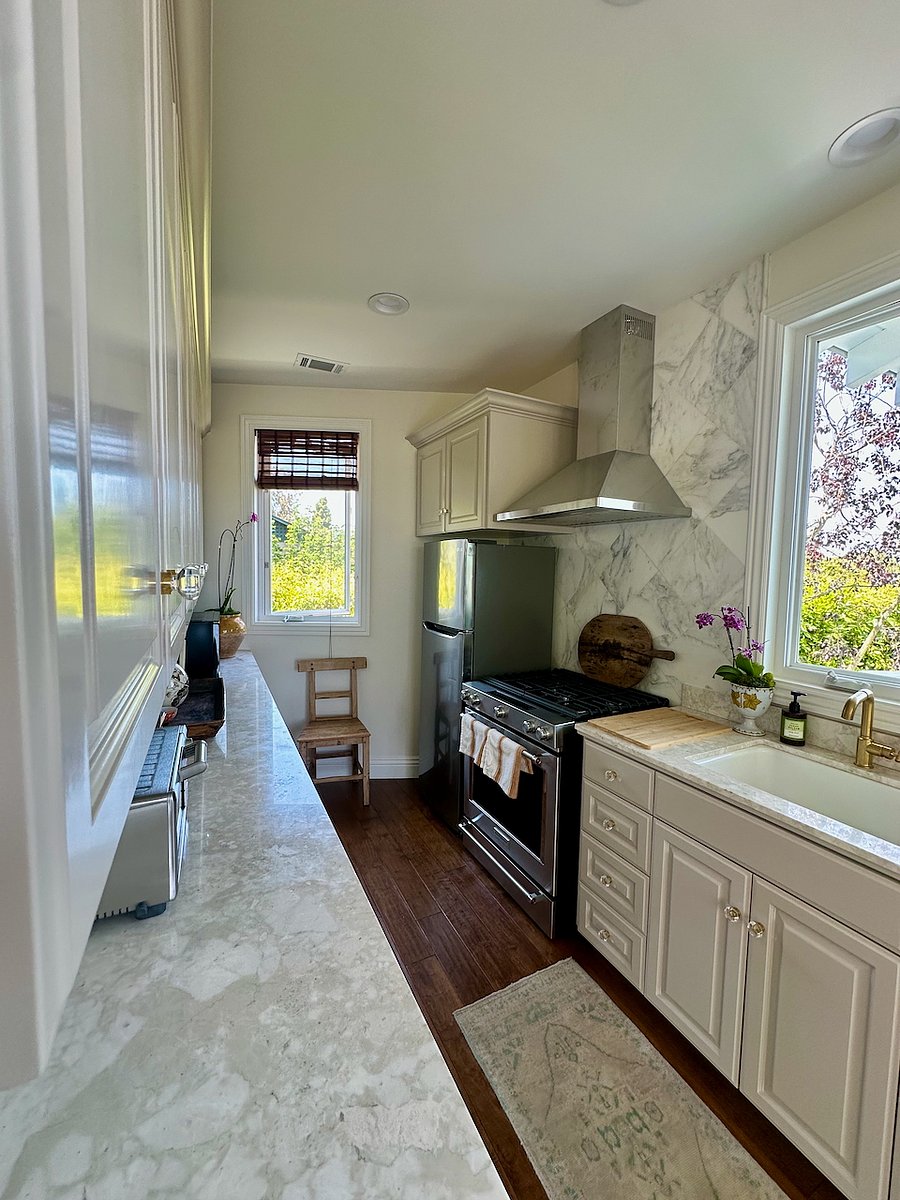Kitchen with view of stove and refrigerator