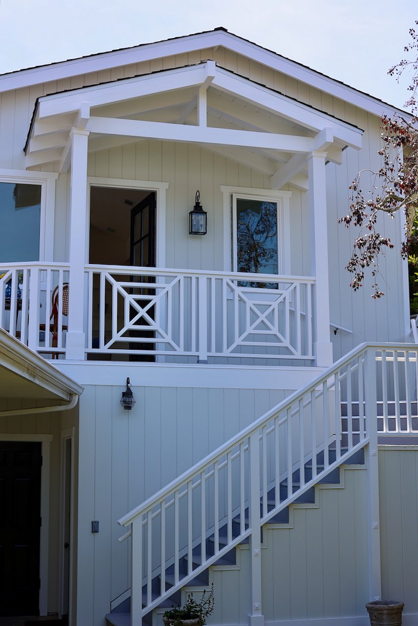 View of stairway entrance and side balcony at front door