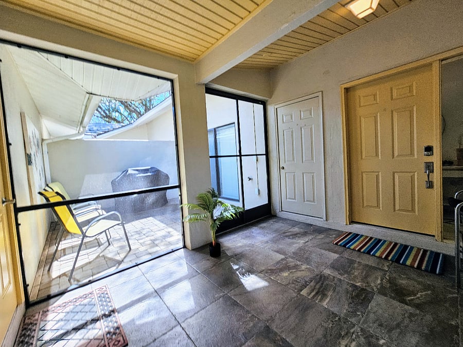 Private courtyard and enclosed entryway between garage and house entrance