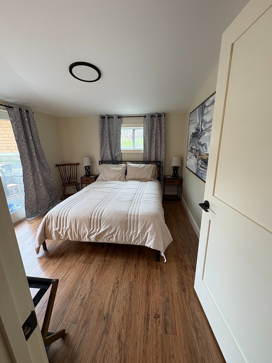 Cozy queen size bed with closet and sliding glass door to outdoor sitting area.