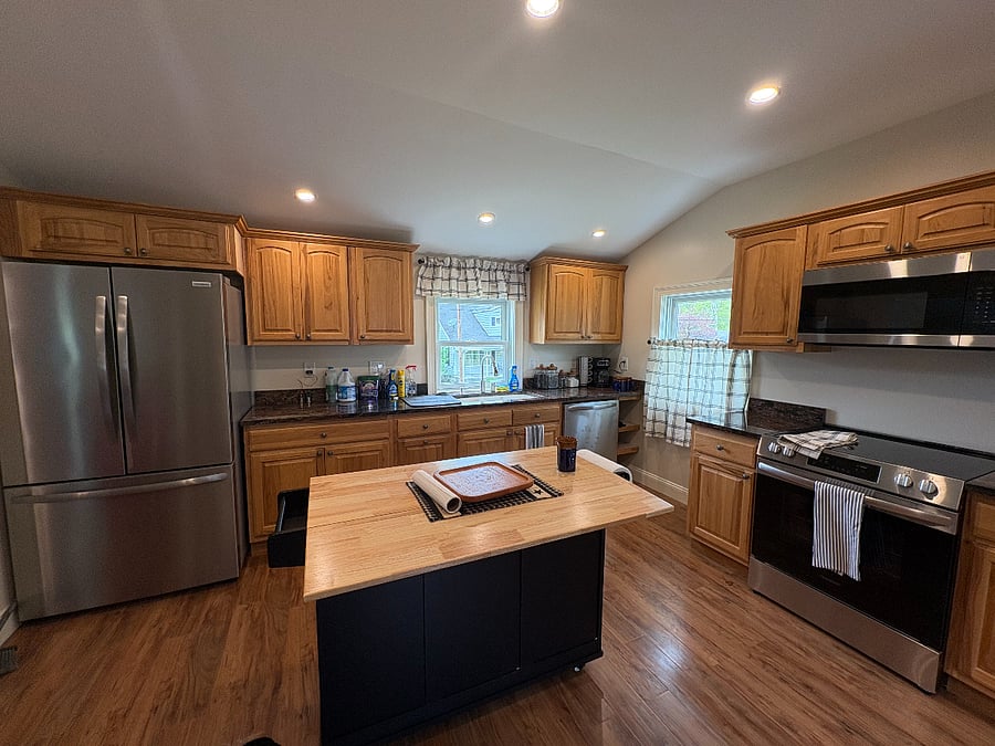 Modern new kitchen with granite counter tops, new appliances, center island and dining table for 4. Additional seating at center island.